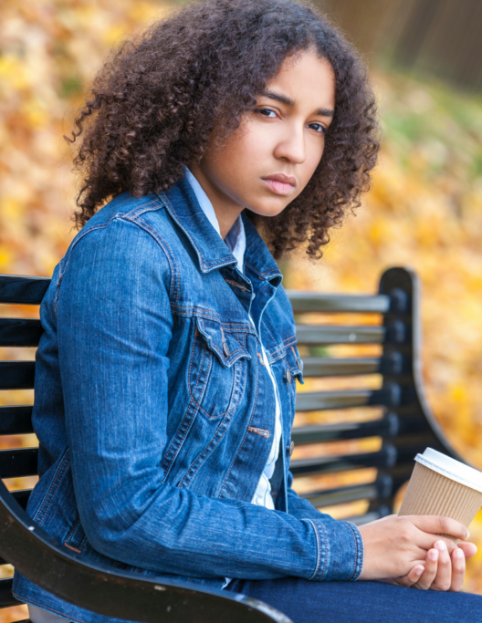 Girl on park bench looking off