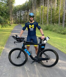 Tyler Thomas with his bike, racing for Aphasia Awareness
